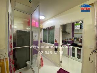 Modern kitchen with glass partition and purple cabinets