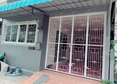 Exterior view of the house with metal gate