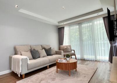 Modern living room with hardwood flooring and natural light