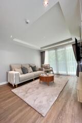 Modern living room with hardwood flooring and natural light