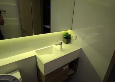 Modern bathroom with vanity and backlit mirror