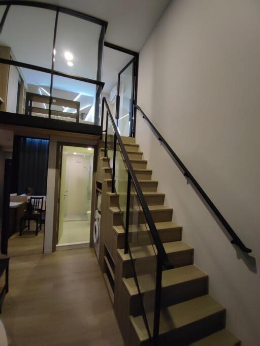 Interior of a modern loft with a staircase leading to a mezzanine level