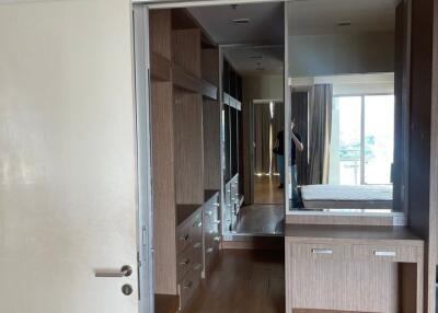 Spacious bedroom with mirrored closet and wooden flooring