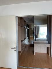 Spacious bedroom with mirrored closet and wooden flooring