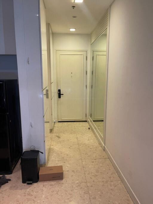 Bright hallway with mirror and tiled floor