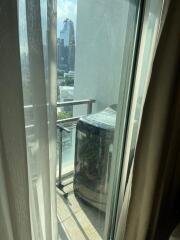 Small balcony with washing machine and city view