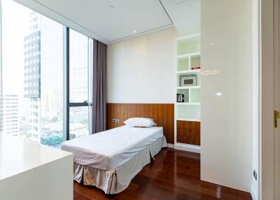 Modern bedroom with large window and built-in shelving