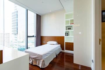 Modern bedroom with large window and built-in shelving