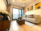 Contemporary living room with a balcony view, sofa, coffee table, and wall decorations