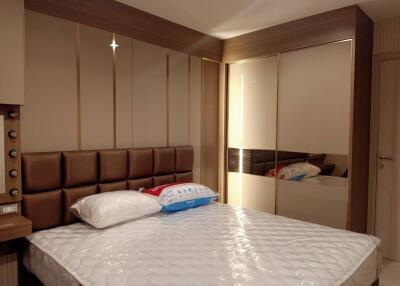 Comfortable bedroom with modern decor and mirrored wardrobe