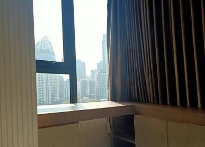 Bedroom with large window and city view