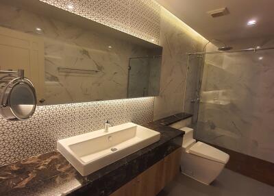 Modern bathroom with illuminated mirrors and marble finishes