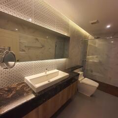 Modern bathroom with illuminated mirrors and marble finishes