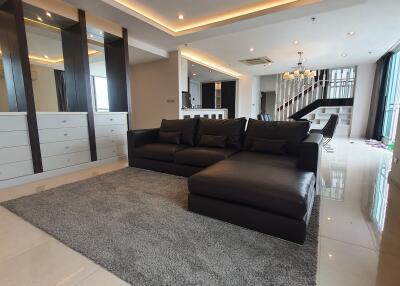 modern living room with black sofa and dining area