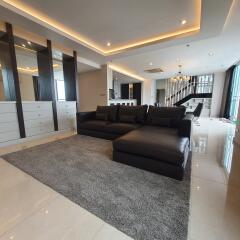 modern living room with black sofa and dining area