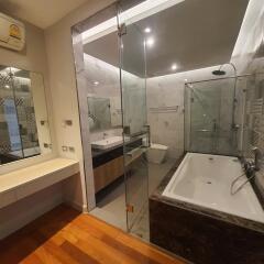 Modern bathroom with bathtub, shower, and vanity