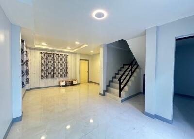 Spacious living room with stairs and modern lighting