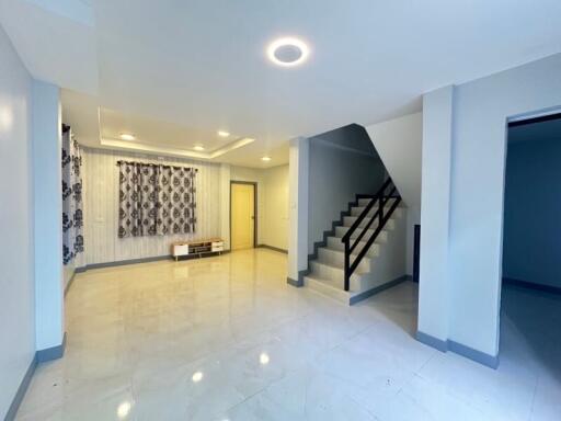 Spacious living room with stairs and modern lighting