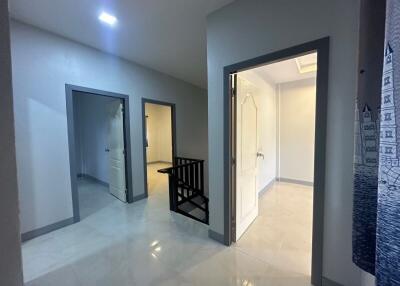 Spacious hallway with multiple doors and staircase