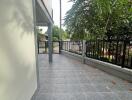 Outdoor patio area with tiled floor and railing