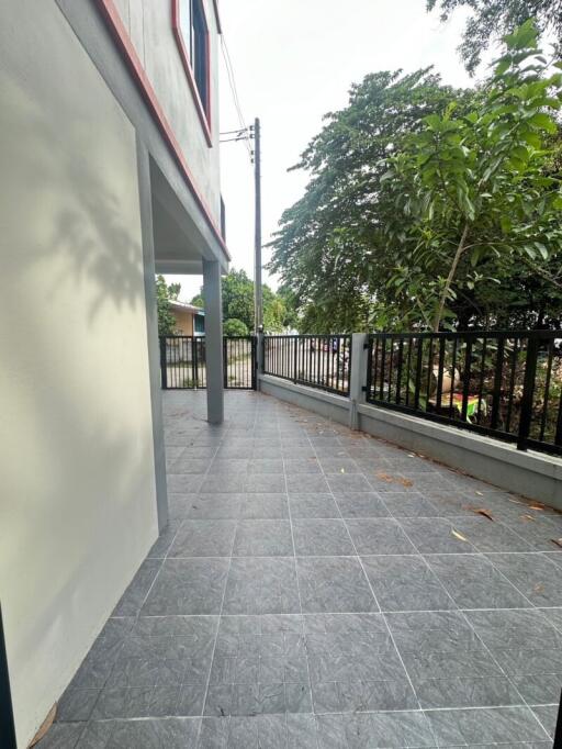 Outdoor patio area with tiled floor and railing