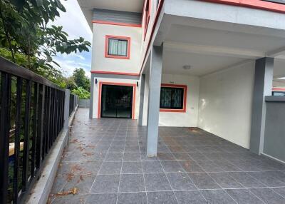 Two-story home with carport and balcony