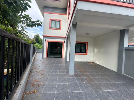 Two-story home with carport and balcony