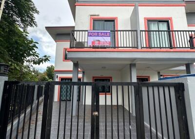 Front view of a two-story house with a balcony and a 