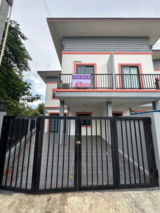 Front view of a two-story house with a balcony and a 