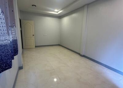 Empty bedroom with tiled floor and ceiling lights