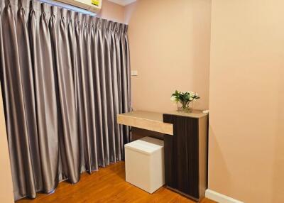 Bedroom with a small desk and stool