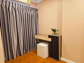 Bedroom with a small desk and stool