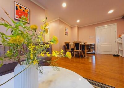 Living room with dining area and entrance door