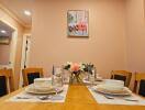 Dining room with table set for four and artwork on the wall