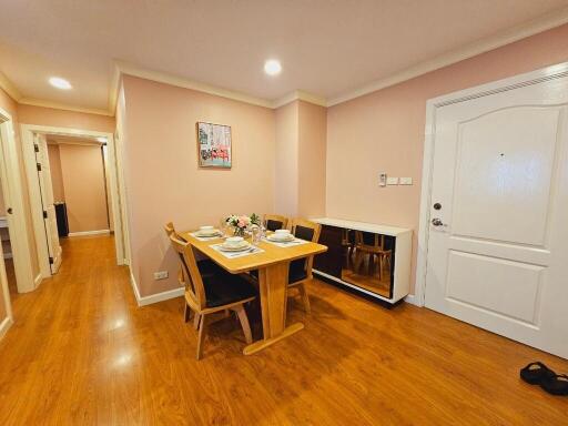 Well-lit dining area with wooden flooring