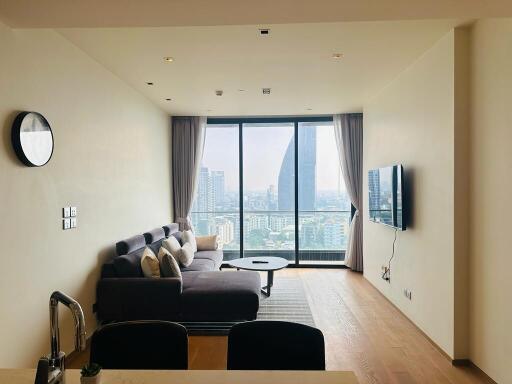 Modern living room with a large window and city view