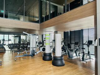 modern gym with fitness equipment and large windows