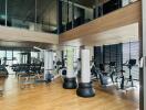 modern gym with fitness equipment and large windows