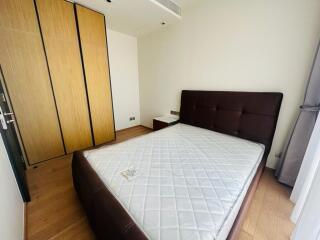 Bedroom with wooden wardrobe and large bed