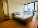 Modern bedroom with large window and city view