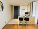 Modern kitchen with breakfast bar and two stools