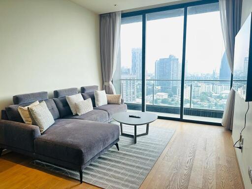 Spacious living room with a large window and modern furniture