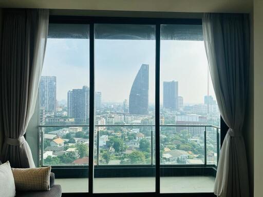 Living room with a large window offering a cityscape view