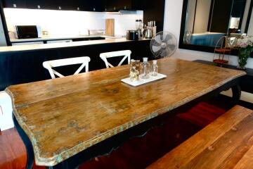 Spacious kitchen area with a large wooden dining table