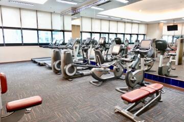 Well-equipped gym with various exercise machines and cardio equipment