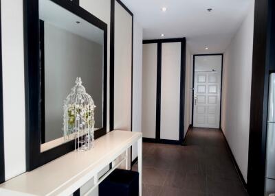 Modern hallway with a large mirror and decorative plant