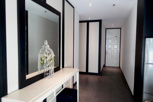 Modern hallway with a large mirror and decorative plant