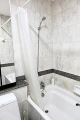 Modern bathroom with marble-like tiles and shower