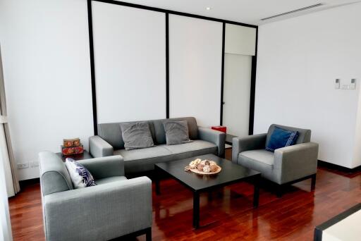 Modern living room with gray furniture and wooden flooring