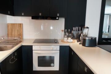 Modern kitchen with black cabinets and white countertops